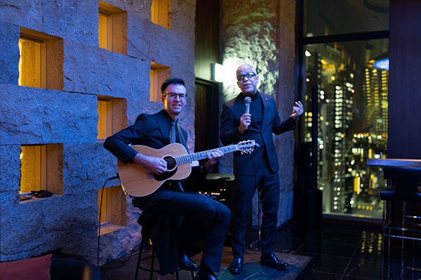 Jesse Forest and Stuart Mansfield performing on stage at IHG Hotel in Osaka, a guitar and vocal duo.